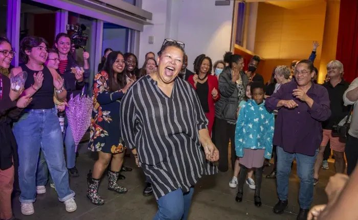莎拉Willie-LeBreton dances with Smith community members at her inauguration party.